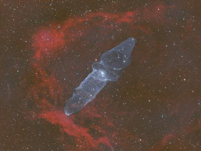 Glowing wave patterns moving across a dark void space